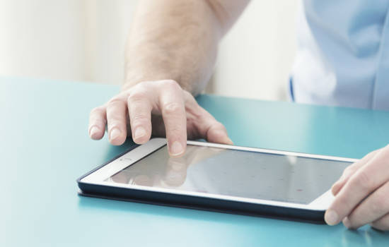 Doctor Checking Information On Tablet YC8PV5H