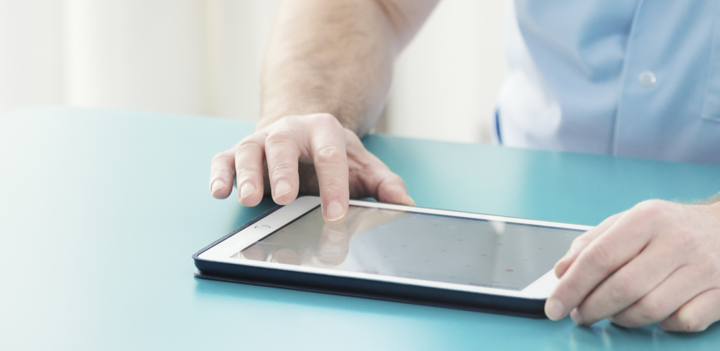 Doctor Checking Information On Tablet YC8PV5H