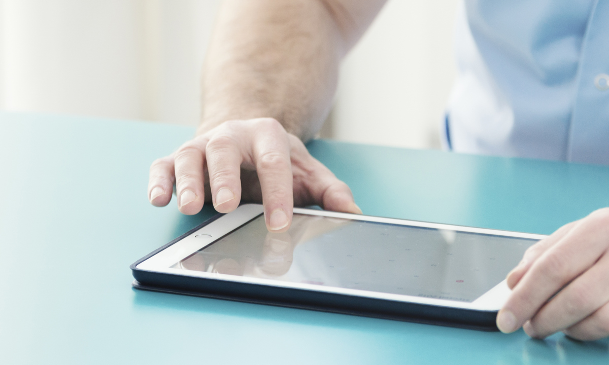 Doctor Checking Information On Tablet YC8PV5H